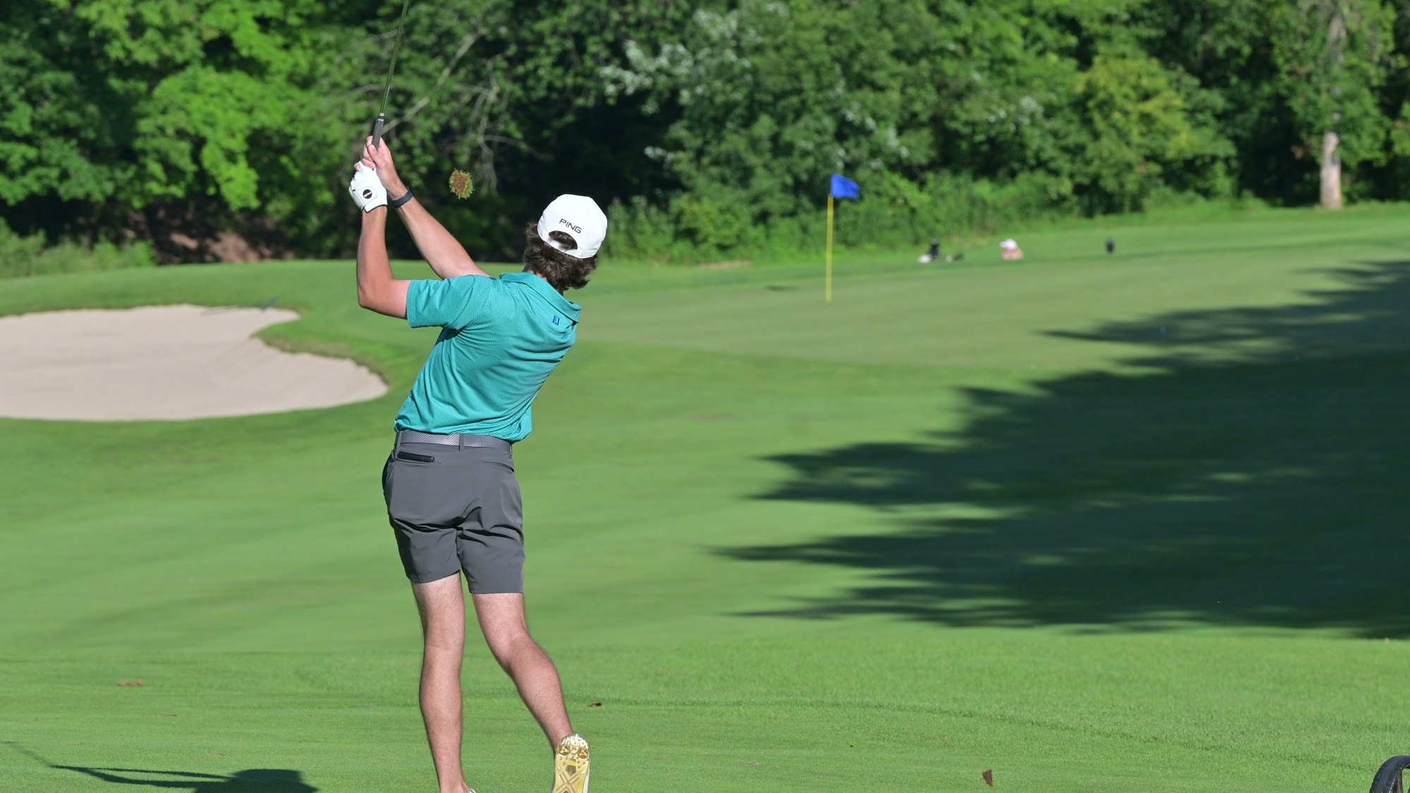 Nic Hughes holding his finish on an approach shot toward the green